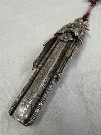 A fine Chinese silver pendant with inscriptions on a plexiglas stand, 19th C.