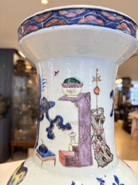 A Chinese doucai and famille rose rouleau vase with figures among antiquities, 19th C.