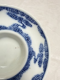 A pair of Chinese inscribed blue and white 'Clouds' tea bowls, covers and stands, Guangxu mark and of the period