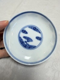 A pair of Chinese inscribed blue and white 'Clouds' tea bowls, covers and stands, Guangxu mark and of the period