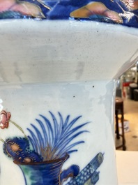 A Chinese doucai and famille rose rouleau vase with figures among antiquities, 19th C.