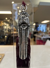 A fine Chinese silver pendant with inscriptions on a plexiglas stand, 19th C.