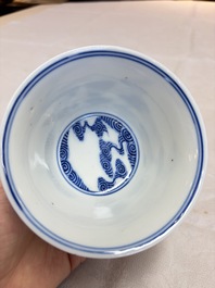 A pair of Chinese inscribed blue and white 'Clouds' tea bowls, covers and stands, Guangxu mark and of the period