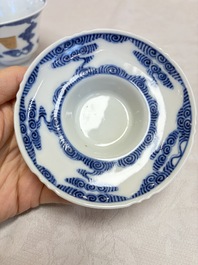 A pair of Chinese inscribed blue and white 'Clouds' tea bowls, covers and stands, Guangxu mark and of the period