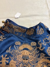 A Chinese embroidered silk blue-ground 'Dragons' robe, adapted into a lady's dress, 19th C. and later