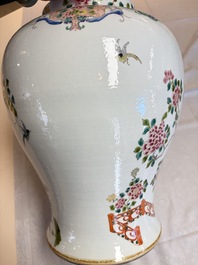 A pair of Chinese famille rose 'Phoenixes among Flowering Branches' vases and covers, 20th C.