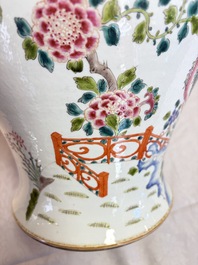 A pair of Chinese famille rose 'Phoenixes among Flowering Branches' vases and covers, 20th C.