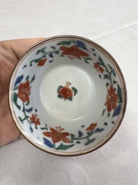 A Chinese famille rose capucine-ground covered teapot with floral design, seven cups and saucers, Yongzheng/Qianlong