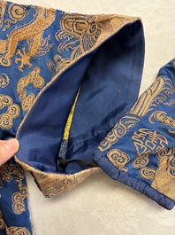 A Chinese embroidered silk blue-ground 'Dragons' robe, adapted into a lady's dress, 19th C. and later
