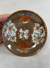 A Chinese famille rose capucine-ground covered teapot with floral design, seven cups and saucers, Yongzheng/Qianlong