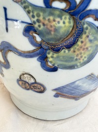 A Chinese doucai and famille rose rouleau vase with figures among antiquities, 19th C.
