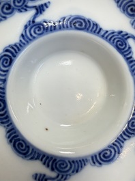 A pair of Chinese inscribed blue and white 'Clouds' tea bowls, covers and stands, Guangxu mark and of the period