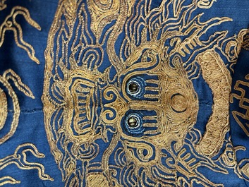 A Chinese embroidered silk blue-ground 'Dragons' robe, adapted into a lady's dress, 19th C. and later