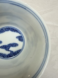 A pair of Chinese inscribed blue and white 'Clouds' tea bowls, covers and stands, Guangxu mark and of the period