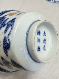 A pair of Chinese inscribed blue and white 'Clouds' tea bowls, covers and stands, Guangxu mark and of the period