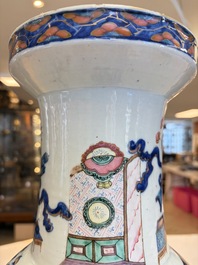 A Chinese doucai and famille rose rouleau vase with figures among antiquities, 19th C.