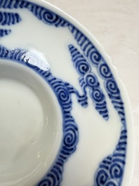 A pair of Chinese inscribed blue and white 'Clouds' tea bowls, covers and stands, Guangxu mark and of the period