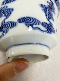 A pair of Chinese inscribed blue and white 'Clouds' tea bowls, covers and stands, Guangxu mark and of the period