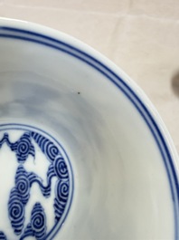 A pair of Chinese inscribed blue and white 'Clouds' tea bowls, covers and stands, Guangxu mark and of the period