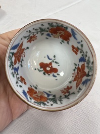 A Chinese famille rose capucine-ground covered teapot with floral design, seven cups and saucers, Yongzheng/Qianlong