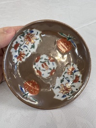 A Chinese famille rose capucine-ground covered teapot with floral design, seven cups and saucers, Yongzheng/Qianlong