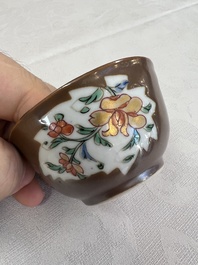A Chinese famille rose capucine-ground covered teapot with floral design, seven cups and saucers, Yongzheng/Qianlong