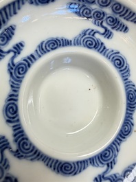 A pair of Chinese inscribed blue and white 'Clouds' tea bowls, covers and stands, Guangxu mark and of the period