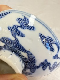 A pair of Chinese inscribed blue and white 'Clouds' tea bowls, covers and stands, Guangxu mark and of the period