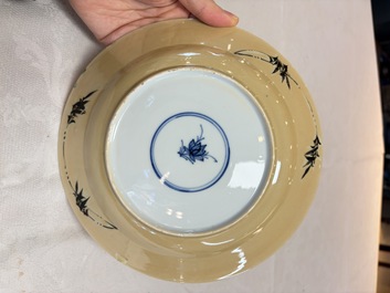 A pair of Chinese famille verte caf&eacute;-au-lait-ground plates with floral design, lotus mark, Kangxi