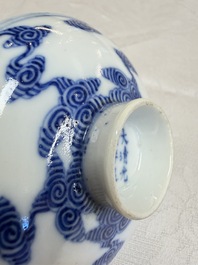 A pair of Chinese inscribed blue and white 'Clouds' tea bowls, covers and stands, Guangxu mark and of the period