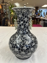 A rare Chinese famille noire 'Prunus on Cracked Ice' vase with 'Chilong' handles, 19th C.
