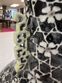 A rare Chinese famille noire 'Prunus on Cracked Ice' vase with 'Chilong' handles, 19th C.