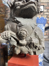 A pair of Chinese carved stone Buddhist lions on later red-lacquered wooden stands, Fujian, Qing