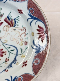 A pair of Chinese famille rose 'Winged Putti' plates, Yongzheng/Qianlong