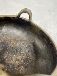 A Chinese bronze two-handled tripod censer, Xuande mark, 19th C.