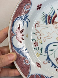 A pair of Chinese famille rose 'Winged Putti' plates, Yongzheng/Qianlong