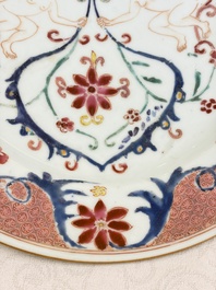 A pair of Chinese famille rose 'Winged Putti' plates, Yongzheng/Qianlong