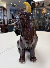 A Chinese sancai-glazed Xiezhi on a wooden stand, 19th C.