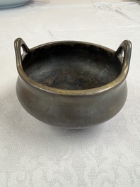 A Chinese bronze two-handled tripod censer, Xuande mark, 19th C.