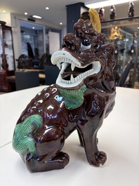 A Chinese sancai-glazed Xiezhi on a wooden stand, 19th C.