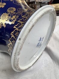 A Chinese gilt-decorated powder-blue-ground vase and cover, Kangxi mark, 19th C.