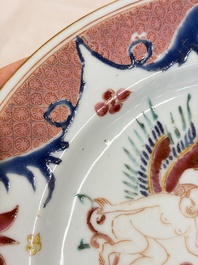 A pair of Chinese famille rose 'Winged Putti' plates, Yongzheng/Qianlong