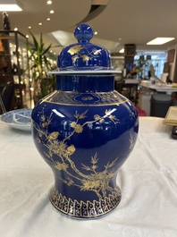 A Chinese gilt-decorated powder-blue-ground vase and cover, Kangxi mark, 19th C.