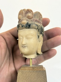 A rare Chinese polychrome carved white marble head of a Bodhisattva on a stand, Northern Qi