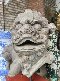 A pair of Chinese carved stone Buddhist lions on later red-lacquered wooden stands, Fujian, Qing