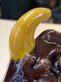 A Chinese sancai-glazed Xiezhi on a wooden stand, 19th C.