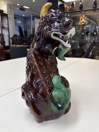 A Chinese sancai-glazed Xiezhi on a wooden stand, 19th C.