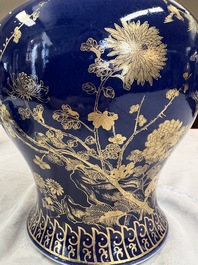 A Chinese gilt-decorated powder-blue-ground vase and cover, Kangxi mark, 19th C.