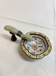 A Chinese celadon jade belt hook mounted as a handle on a Canton enamel bowl, Qing