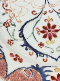 A pair of Chinese famille rose 'Winged Putti' plates, Yongzheng/Qianlong
